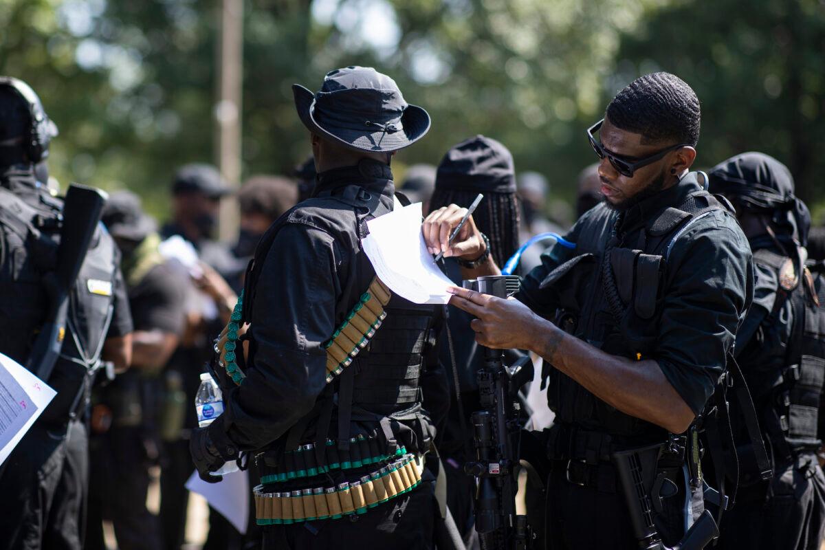 Members of a protest group affiliated with NFAC, most carrying firearms, gather to march in Louisville, Ky., on July 25, 2020. (Brett Carlsen/Getty Images)