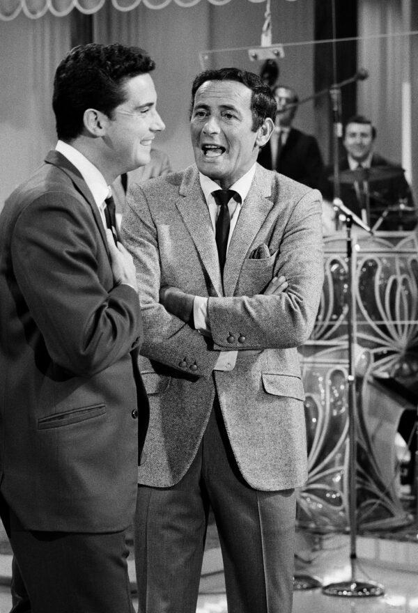 Regis Philbin, of "The Joey Bishop Show" goes over the upcoming routines with Joey Bishop, right, on the set of the ABC-TV studio in Los Angeles on Sept. 15, 1967. (AP Photo)