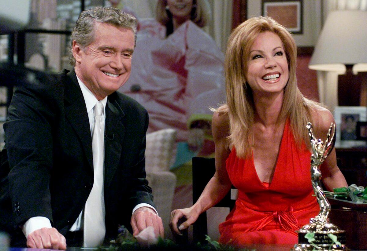 Kathie Lee Gifford and co-host Regis Philbin reminisce during her last appearance on the show in New York, N.Y., on July 28, 2000. (Richard Drew/AP Photo)
