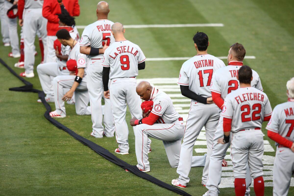 Justin Upton #10 of the Los Angeles Angels kneels during the National Anthem before their opening day game against the Oakland Athletics at Oakland-Alameda County Coliseum in Oakland, Calif., on July 24, 2020. (Ezra Shaw/Getty Images)