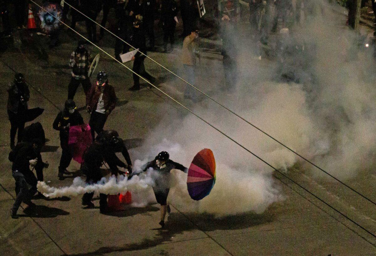 Demonstrators clash with police near the Seattle Police Department's East Precinct shortly after midnight in Seattle, Wash., on June 8, 2020. (David Ryder/Getty Images)