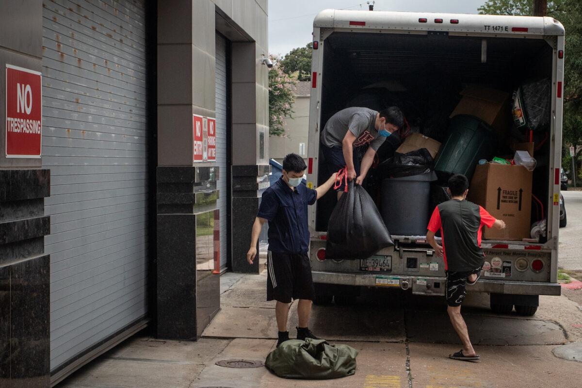 Men load bags full of belongings from China's Consulate into the back of a moving truck in Houston, Texas, on July 24, 2020. (Adrees Latif/Reuters)