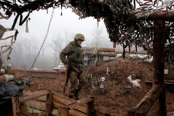 A Ukrainian soldier takes position on the front line at the town of Novoluhanske in the Donetsk region, Ukraine, on Dec. 9 2019. (Vitali Komar/AP Photo)