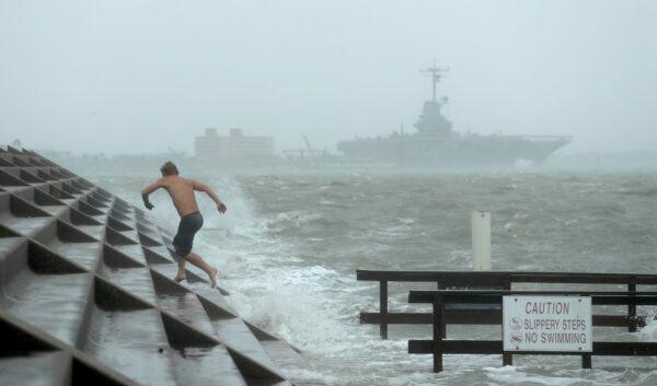 A man jumps from a wave as Hurricane Hanna begins to make landfall, in Corpus Christi, Texas, on July 25, 2020. (Eric Gay/AP Photo)
