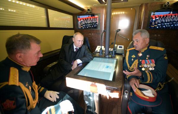 Russian President Vladimir Putin, Defence Minister Sergei Shoigu and Commander of the Western Military District of Russian Armed Forces Alexander Zhuravlyov are pictured aboard the Raptor patrol boat before the Navy Day parade in Saint Petersburg, Russia, on July 26, 2020.(Sputnik/Alexei Druzhinin/Kremlin via Renters)