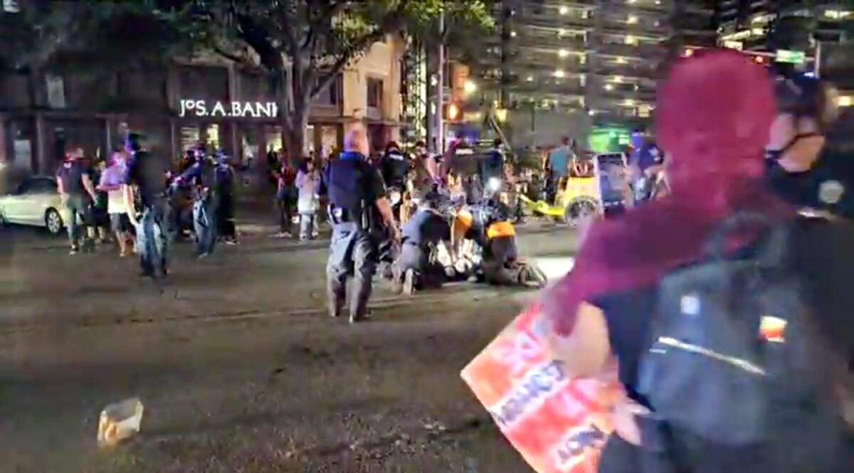 Police and protesters gather around a demonstrator who got shot after several shots were fired during a Black Lives Matter protest in downtown Austin, Texas, on July 25, 2020 in this screen grab obtained from a social media video. (ImHiram/Hiram Gilberto/www.imhiram.com via Reuters)