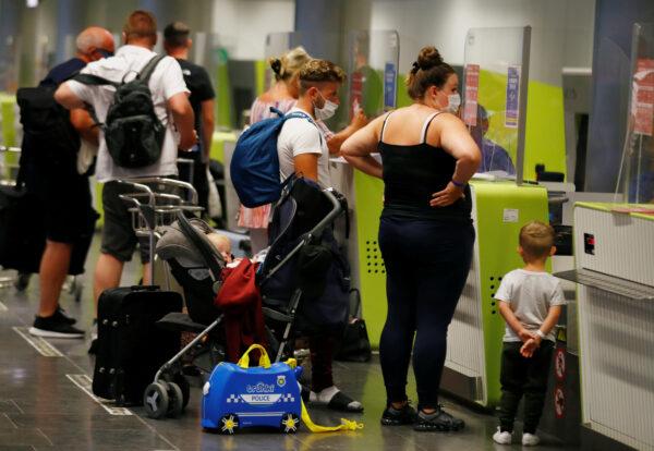 British tourists returning to the UK check in their luggage, as Britain imposed a two-week quarantine on all travellers arriving from Spain, on the island of Gran Canaria, Spain, on July 25, 2020. (Borja Suarez/Reuters)