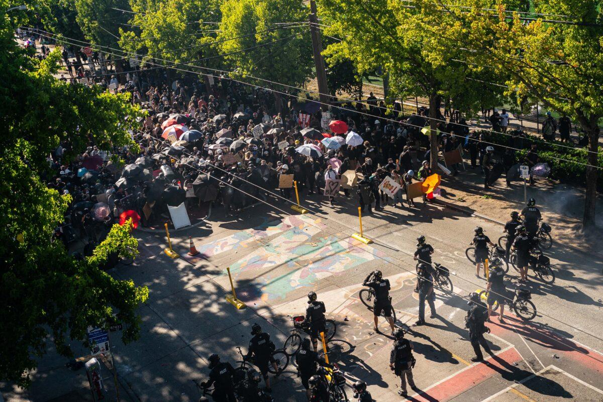 Police push demonstrators back atop a Black Lives Matter street mural in the area formerly known as the Capitol Hill Organized Protest (CHOP) during rioting in Seattle, on July 25, 2020. (David Ryder/Getty Images)