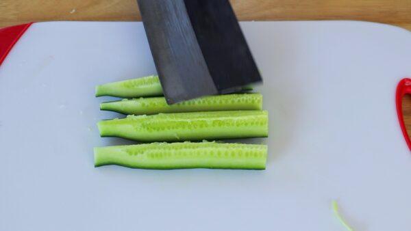 Gently smash the cucumber spears with the flat side of your knife. (photo by CiCi Li)
