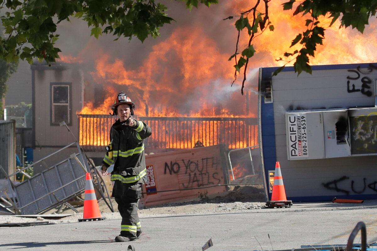 Construction buildings burn near the King County Juvenile Detention Center after being set on fire by rioters in Seattle, Wash., on July 25, 2020. (Ted S. Warren/AP Photo)