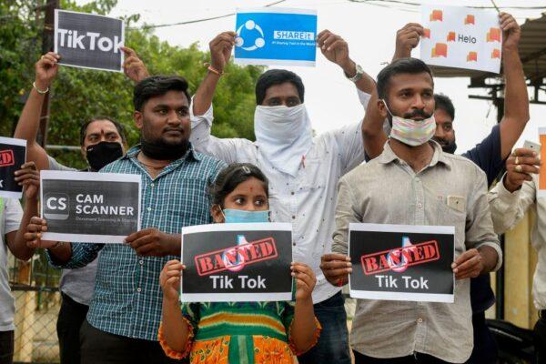 Members of the City Youth Organisation hold posters with the logos of Chinese apps in support of the Indian government for banning the wildly popular video-sharing 'Tik Tok' app, in Hyderabad on June 30, 2020. (Noah Seelam/AFP via Getty Images)