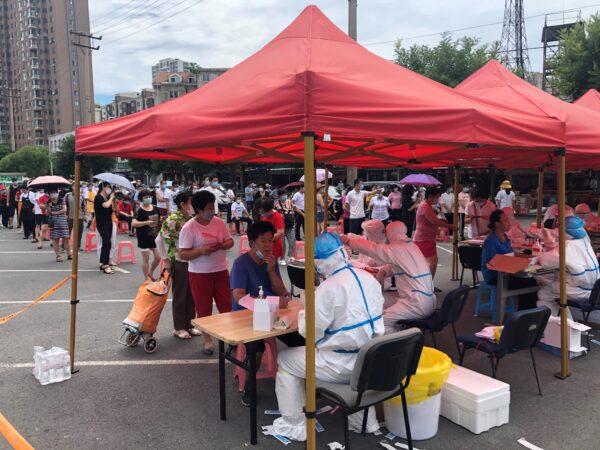 People are lining up to take COVID-19 tests at a makeshift testing center in Dalian city, in China's northeast Liaoning Province on July 26, 2020. (STR/AFP via Getty Images)