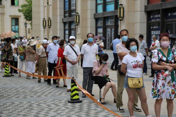 People line up to take COVID-19 tests at a makeshift testing center in Dalian, in China's northeast Liaoning Province on July 27, 2020. (STR/AFP via Getty Images)