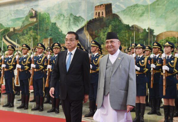 Nepal's Prime Minister K.P. Sharma Oli (center R) reviews a military honor guard with Chinese Premier Li Keqiang during a welcome ceremony at the Great Hall of the People in Beijing on June 21, 2018. (Greg Baker/AFP via Getty Images)