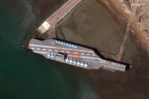 Iran's refurbished mock-up aircraft carrier (C-L), used previously as a simulated U.S. target during a February, 2015 Iranian naval war games exercise, is seen at its home port of Bandar Abbas, Iran, on Feb. 15, 2020. (Satellite image ©2020 Maxar Technologies/via Reuters)