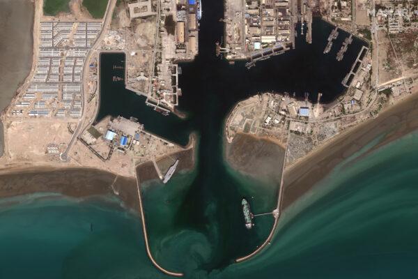 Iran's refurbished mock-up aircraft carrier (C-L), used previously as a simulated U.S. target during a February, 2015 Iranian naval war games exercise, is seen at its home port of Bandar Abbas, Iran, on Feb. 15, 2020. (Satellite image ©2020 Maxar Technologies/via Reuters)