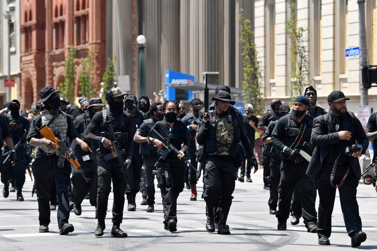 Armed members of the NFAC march in Louisville, Ky., on July 25, 2020. (Timothy D. Easley/AP Photo)