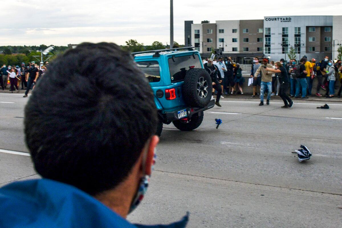 A man shoots at a Jeep speeding on a highway in Aurora, Colo., on July 25, 2020. (Michael Ciaglo/Getty Images)