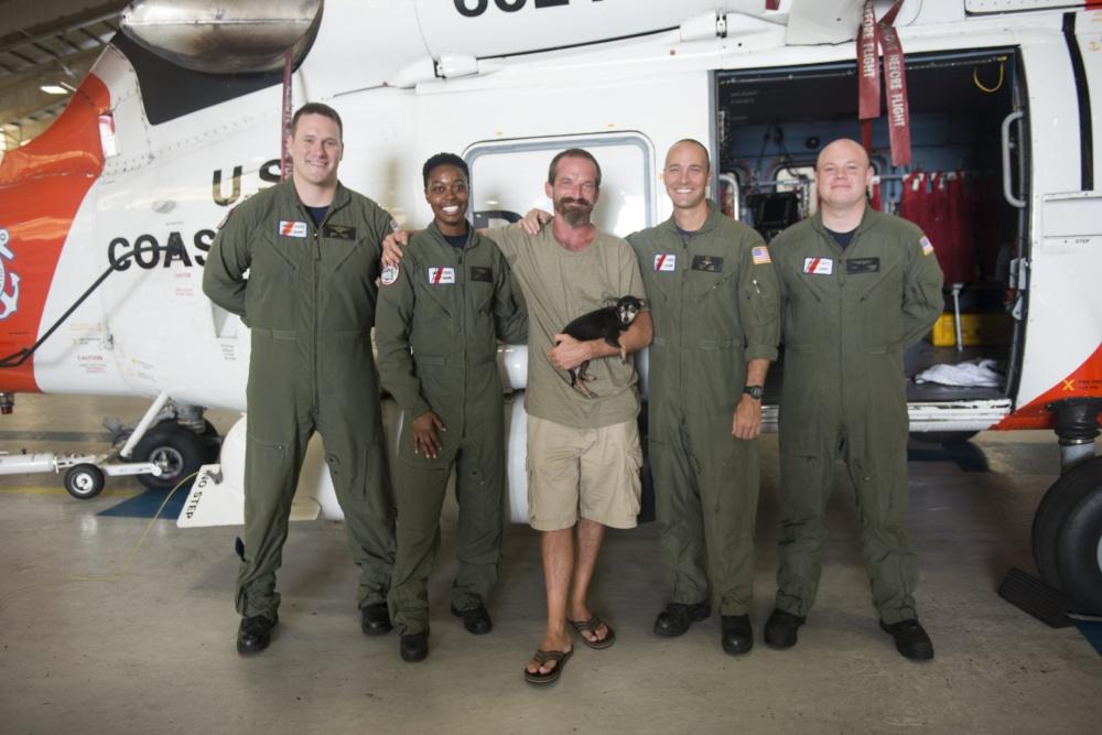 Lee and the aircrew pictured together at Air Station Clearwater in Florida on July 13, 2015 (<a href="https://www.dvidshub.net/image/2059626/survivor-his-dog-meet-their-coast-guard-heroes">Petty Officer 3rd Class Ashley J. Johnson</a>/U.S. Coast Guard)