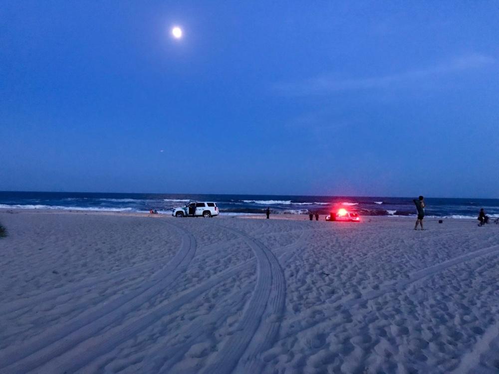 Local EMS and additional first responders arrive on the beach at Fire Island, New York, on July 24, 2018 (<a href="https://www.dvidshub.net/image/4592002/off-duty-coast-guard-member-rescues-2-distressed-swimmers-off-fire-island">U.S. Coast Guard</a>)