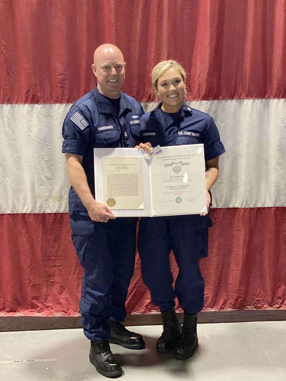 Master Chief Petty Officer Jason M. Vanderhaden with his daughter, Petty Officer 2nd Class Victoria Vanderhaden, in Mobile, Alabama, on July 20, 2020 (<a href="https://www.dvidshub.net/image/6280760/coast-guard-member-receives-silver-lifesaving-medal-mobile">Chief Petty Officer Crystalynn Kneen</a>/U.S. Coast Guard)