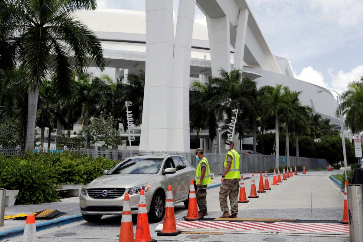 Members of the Florida National Guard monitor vehicles at a COVID-19 testing site outside of Marlins Park in Miami, Fla., on July 27, 2020. (Lynne Sladky/AP Photo)