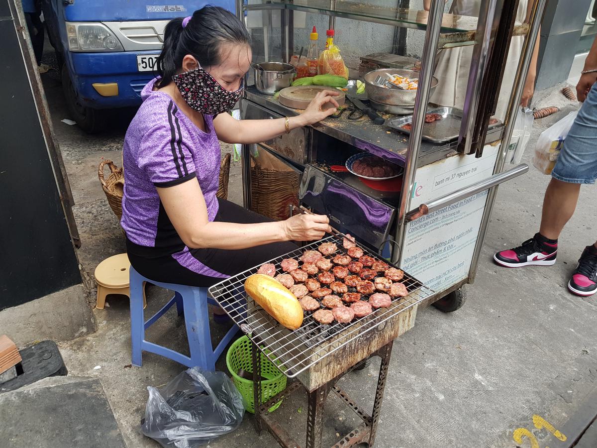 Grilling pork patties to order. (James Clark/<a href="http://nomadicnotes.com/">NomadicNotes.com</a>)