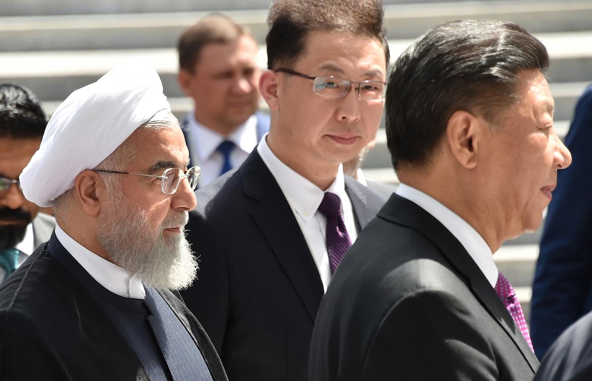 Iran's President Hassan Rouhani (L) and Chinese President Xi Jinping (R) walk as they attend a meeting of the Shanghai Cooperation Organisation (SCO) Council of Heads of State in Bishkek on June 14, 2019. (VYACHESLAV OSELEDKO/AFP via Getty Images)