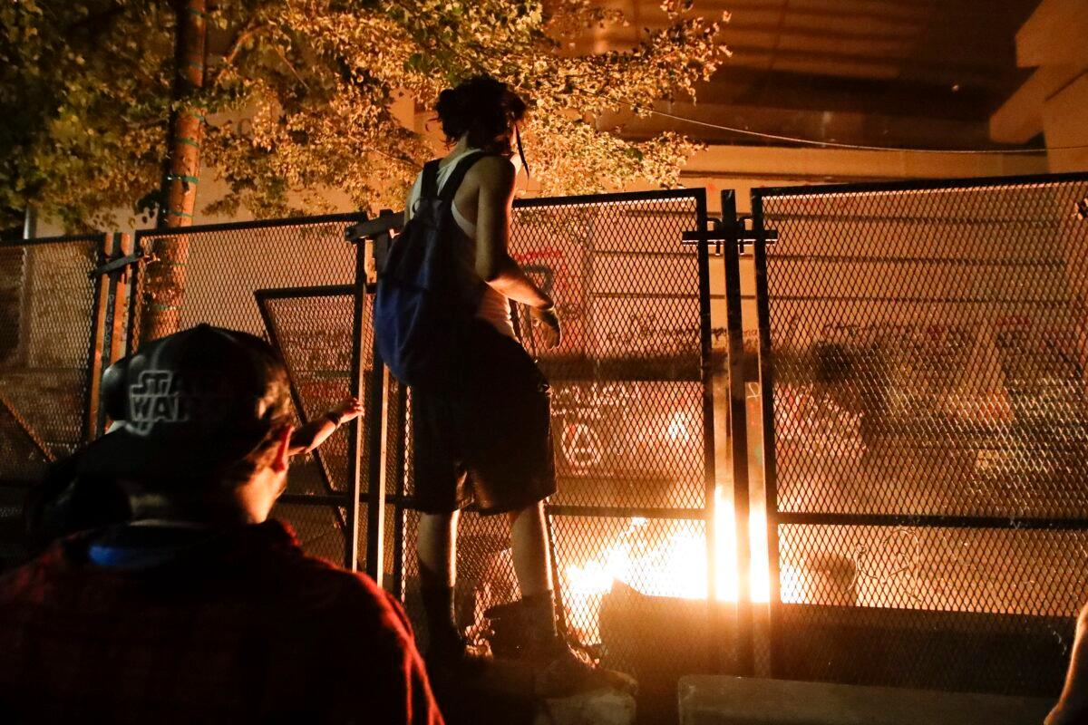 Rioters light a fire at the Mark O. Hatfield Courthouse in Portland, Ore., on July 27, 2020. (Marcio Jose Sanchez/AP Photo)