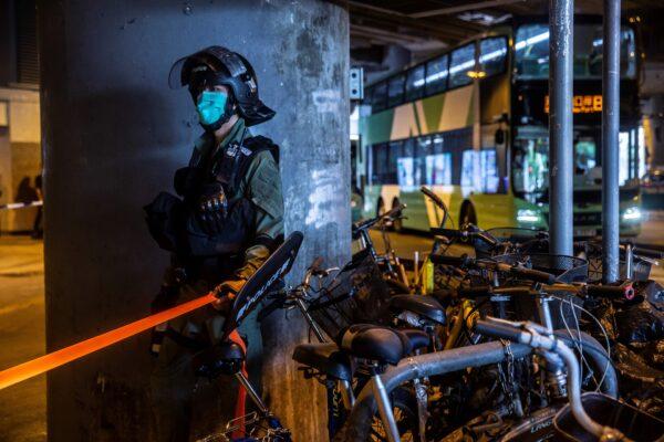 A riot police officer stands guard during a protest by district councilors at a mall in Yuen Long in Hong Kong on July 19, 2020, against a mob attack by suspected triad gang members inside the Yuen Long train station on July 21, 2019. (Isaac Lawrence/AFP via Getty Images)