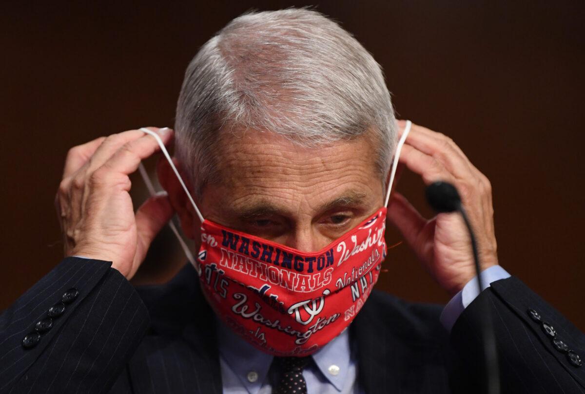 Dr. Anthony Fauci, director of the National Institute for Allergy and Infectious Diseases, lowers his mask before testifying before a Senate committee in Washington on June 30, 2020. (Kevin Dietsch/Pool/Getty Images)