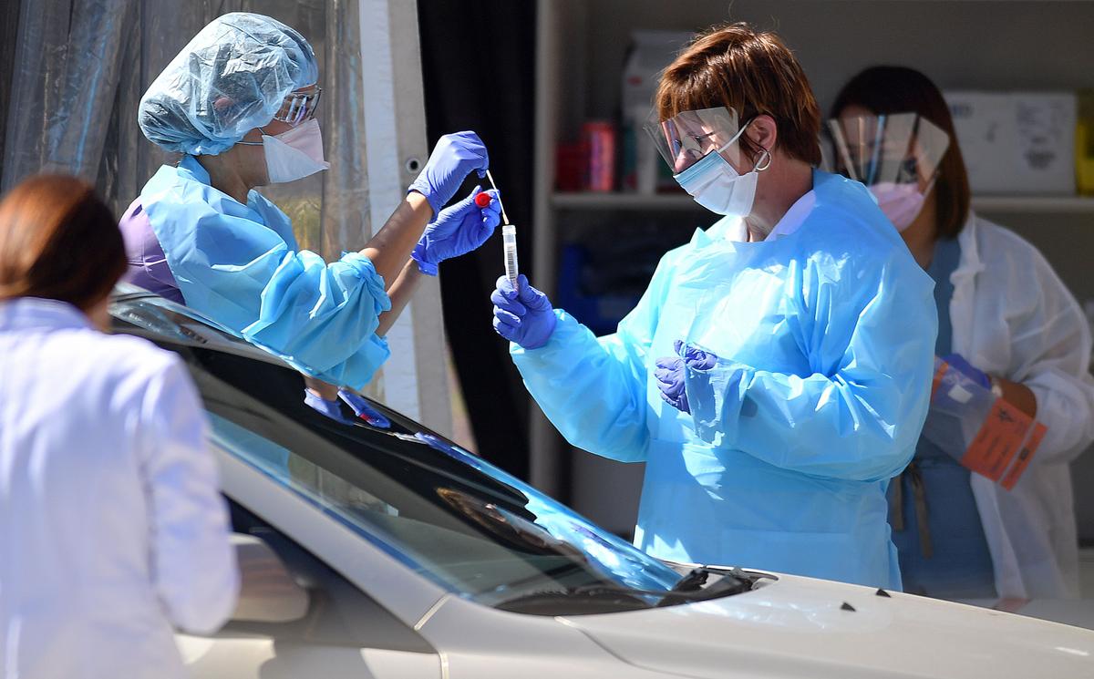 Medical workers at Kaiser Permanente French Campus test a patient for the novel coronavirus at a drive-thru testing facility in San Francisco, Calif., on March 12, 2020. (Josh Edelson/AFP via Getty Images)