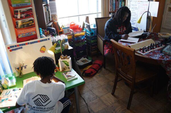 Ayinde (L), age 10, and Zion, 17, do their school work at their home in Washington, DC, on Feb. 24, 2017. (Mandel Ngan/AFP via Getty Images)
