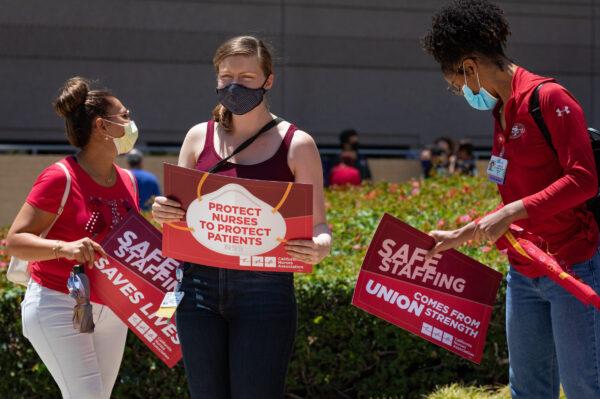 Participants hold signs at a protest by nurses over working conditions due to COVID-19 at the Ronald Reagan UCLA Medical Center in Los Angeles, Calif., on July 29, 2020. (John Fredricks/The Epoch Times)
