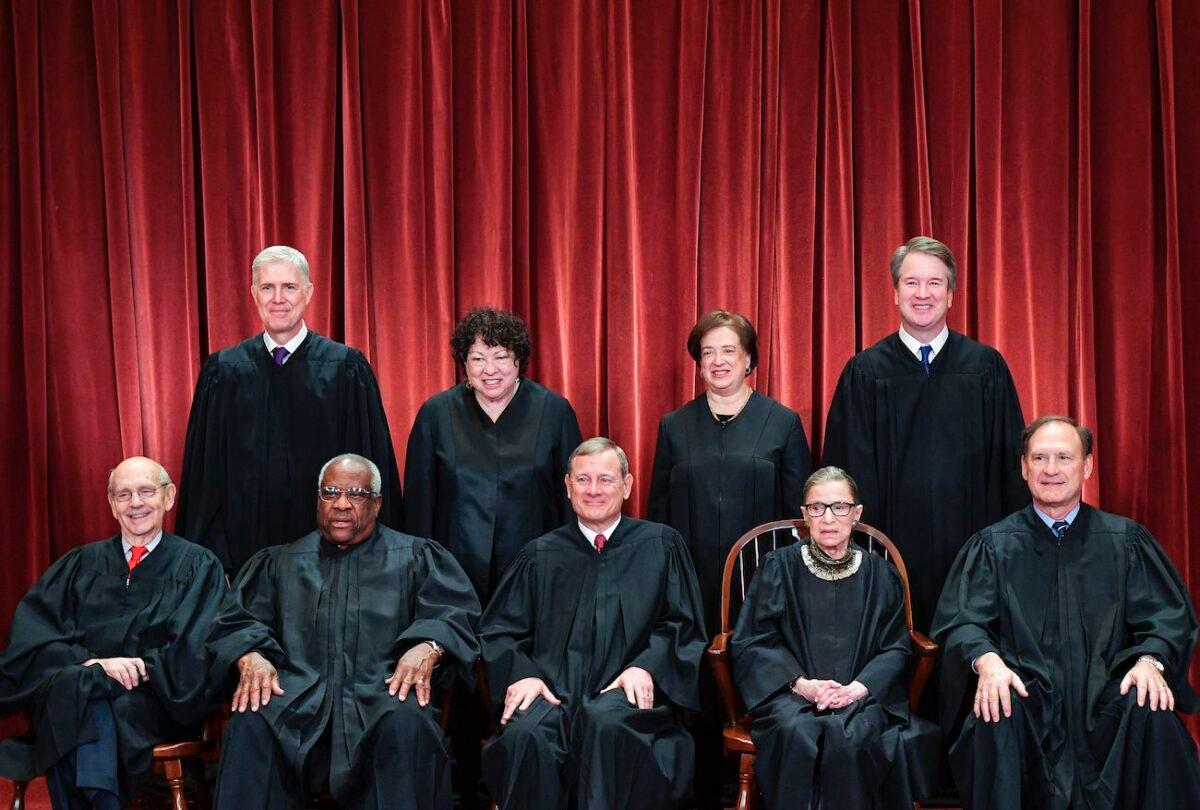  Justices of the U.S. Supreme Court pose for their official photo at the Supreme Court in Washington, on Nov. 30, 2018. Standing from left: Associate Justice Neil Gorsuch, Associate Justice Sonia Sotomayor, Associate Justice Elena Kagan, and Associate Justice Brett Kavanaugh. Seated from left to right, bottom row: Associate Justice Stephen Breyer, Associate Justice Clarence Thomas, Chief Justice John Roberts, Associate Justice Ruth Bader Ginsburg, and Associate Justice Samuel Alito. (Mandel Ngan/AFP via Getty Images)