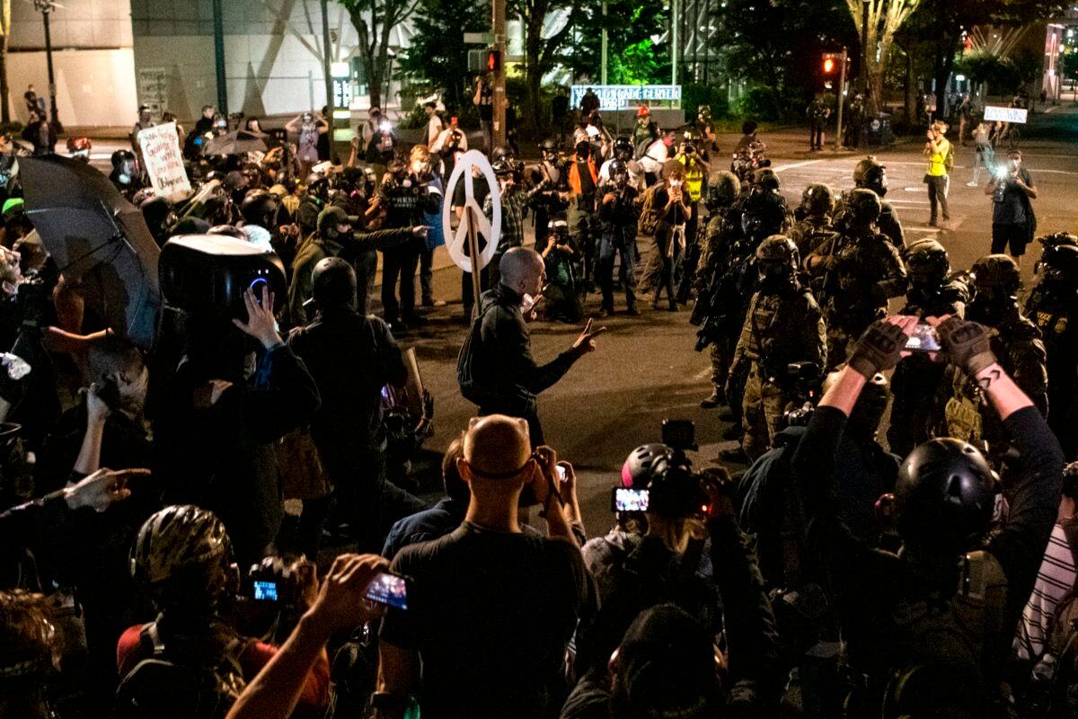 Demonstrators confront law enforcement outside the Mark O. Hatfield Courthouse in Portland, Ore., on July 29, 2020. (Alisha Jucevic/AFP via Getty Images)