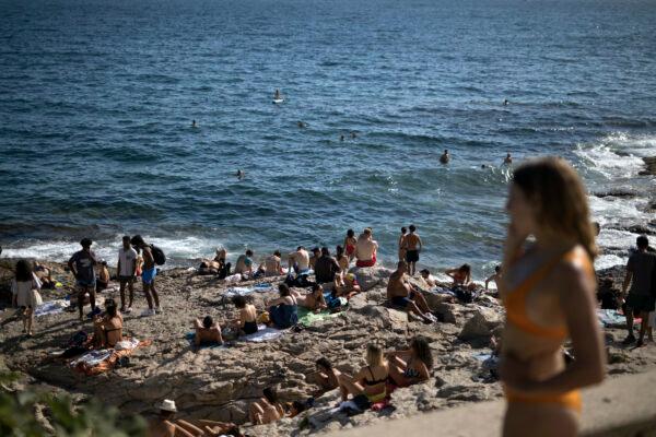People enjoy the sun at the Malmousque Beach in Marseille, in southern France on July 25, 2020. (Daniel Cole/AP Photo)