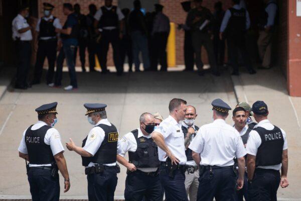 Police officers gather outside Advocate Illinois Masonic Medical Center after an officer was shot at the 25th District police station on the Northwest Side, Chicago, on July 30, 2020. (Pat Nabong/Chicago Sun-Times via AP)