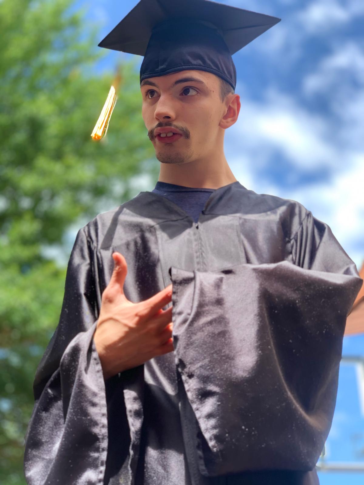 Odin dressed in his high school graduation cap and gown (Courtesy of <a href="https://www.instagram.com/quaruntim/">Tim Frost</a>)