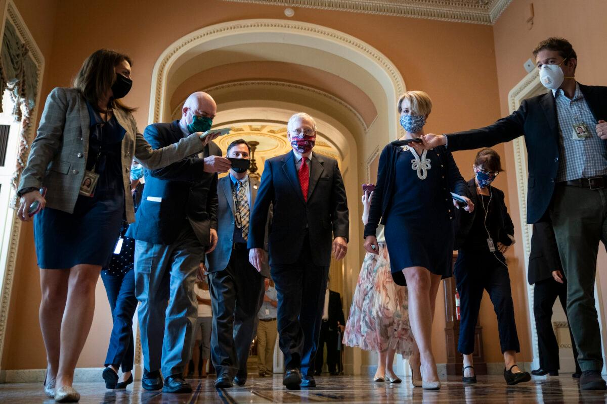 Senate Majority Leader Mitch McConnell (R-KY) is swarmed by reporters as he leaves the Senate floor in Washington, on July 30, 2020. (Drew Angerer/Getty Images)