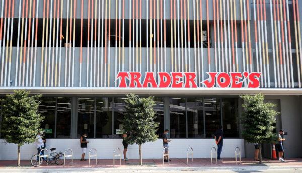 Customers wait in line to enter the Trader Joe's store in Miami Beach, Fla, on April 14, 2020. (Cliff Hawkins/Getty Images)