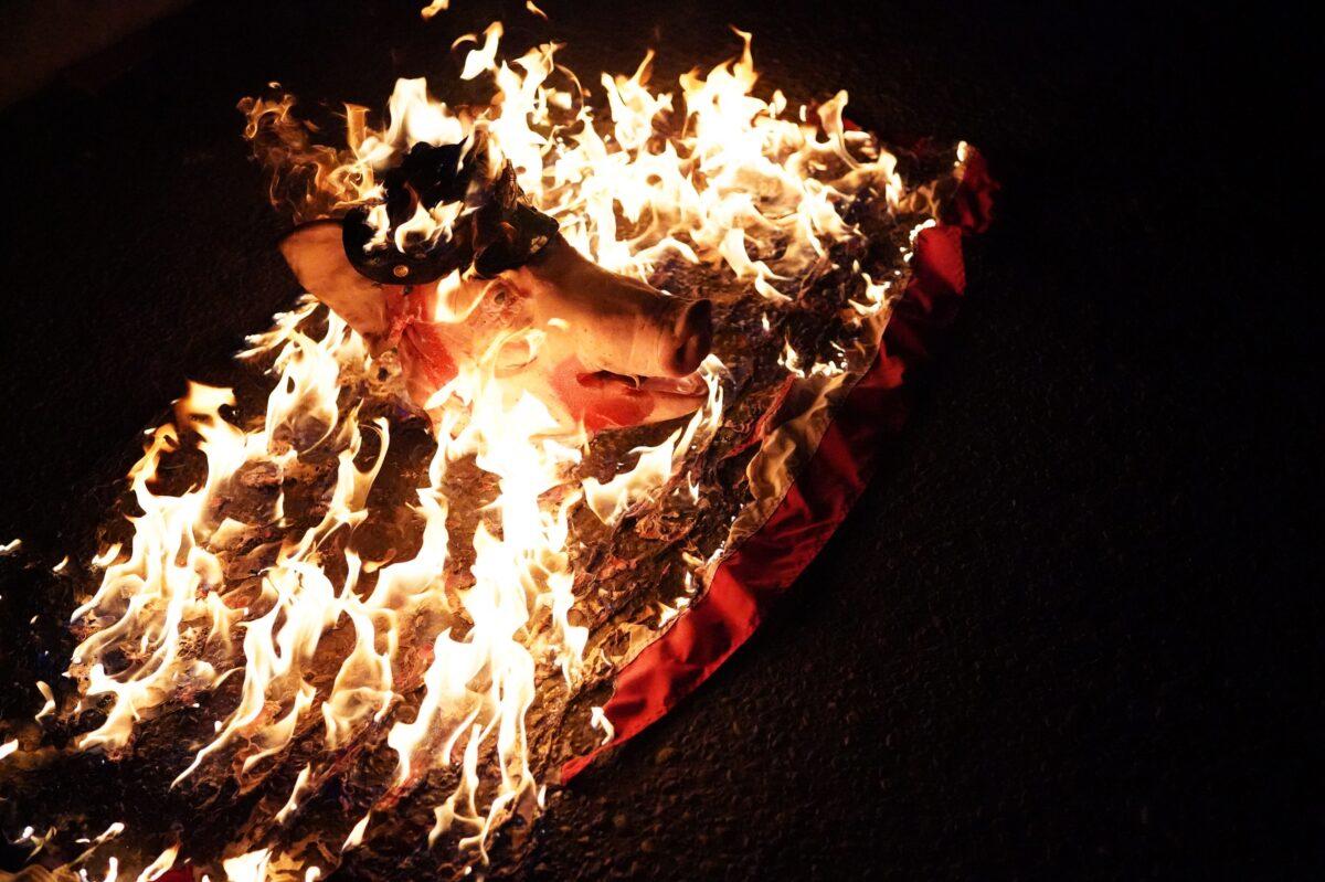 A pig's head with a police hat burns during a protest outside the Mark O. Hatfield Courthouse in Portland, Ore., on July 30, 2020. (Nathan Howard/Getty Images)