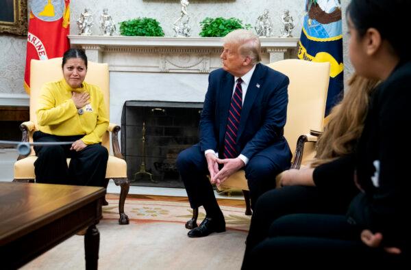 President Donald Trump looks on as the mother of murdered Fort Hood soldier Vanessa Guillen, Gloria Guillen, talks about her daughter's murder during a meeting with the family in the Oval Office of the White House in Washington on July 30, 2020. (Doug Mills/The New York Times via Getty Images)
