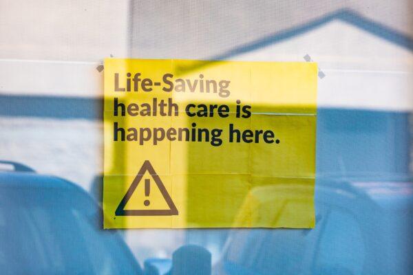 A sign is displayed in the window of a DaVita kidney dialysis center in Van Nuys, Calif., on Aug. 31, 2020. (John Fredricks/The Epoch Times)