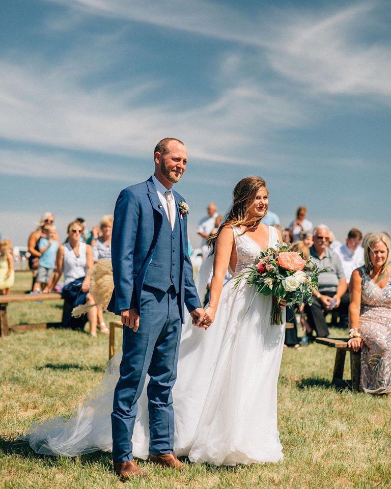Hailey with her husband, Mitch Krull, taking their wedding vows. (Courtesy of <a href="https://www.sandhillsblue.com/">Sandhills Blue Photography</a>)