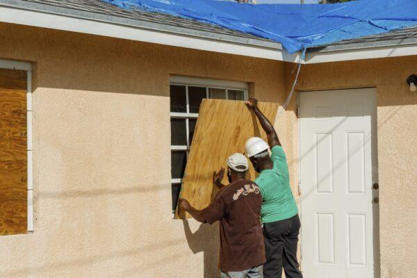 Residents cover a window with plywood in preparation for the arrival of Hurricane Isaias, in the Heritage neighborhood of Freeport, Grand Bahama, Bahamas on July 31, 2020. (Tim Aylen/AP Photo)