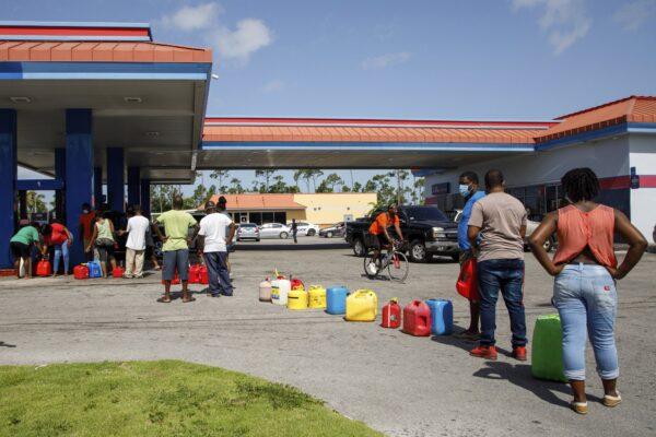 Residents wait in line to fill their containers with gasoline before the arrival of Hurricane Isaias in Freeport, Grand Bahama, Bahamas on July 31, 2020. (Tim Aylen/AP Photo)