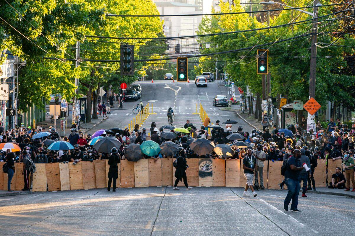 Demonstrators use shields while blocking an intersection near the Seattle Police East Precinct during protests in Seattle on July 26, 2020. (David Ryder/Getty Images)