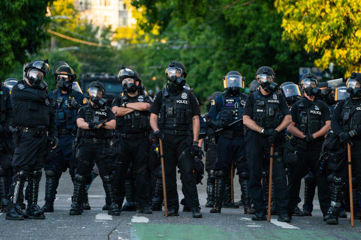 Police block a road during protests near the Seattle Police East Precinct in Seattle on July 26, 2020. (David Ryder/Getty Images)