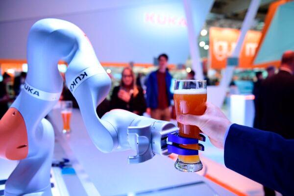 A robot serves beer at the booth of Kuka at the Hanover Fair in Hanover, Germany, on April 24, 2017. (Tobias Schwarz/AFP via Getty Images)